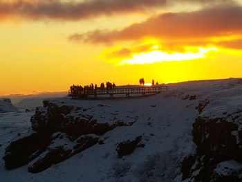 Silhouette of people on beach during sunset