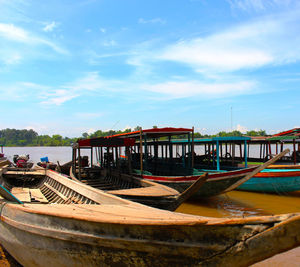 Boats moored in sea against sky