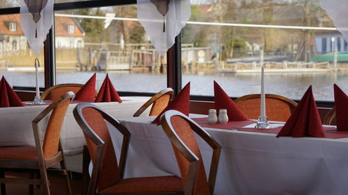 Close-up of chairs on table