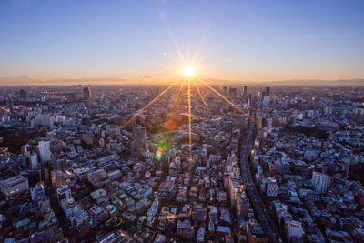 High angle view of illuminated cityscape against sky during sunset