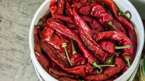 High angle view of red chili peppers in plate on table