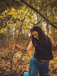 Smiling woman standing in forest