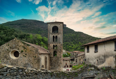 Old historic building by mountain against sky