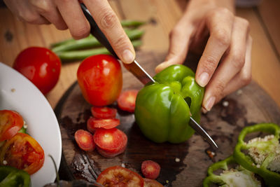 Cropped image of hand holding vegetables