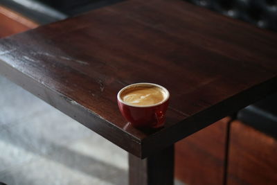 A cup of latte on the wood table