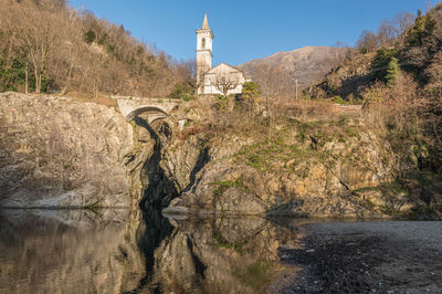 The beautiful ravine of sant'anna with the church reflected in the water of the river