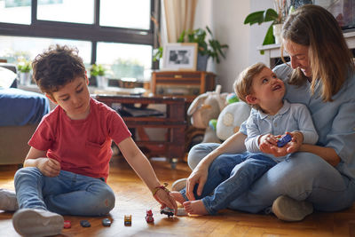 Loving moment of happy mother playing with her children