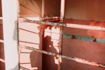 Close-up of rusty window on wall of building