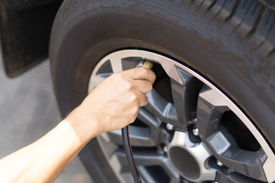 Cropped image of hand holding car