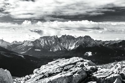 Scenic view of rocky mountains against cloudy sky