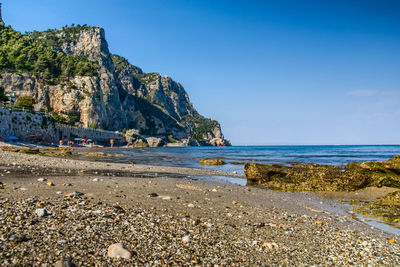 Scenic view of beach against blue sky