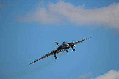 Low angle view of airplane flying in sky