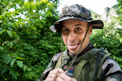 Portrait of smiling soldier against plants