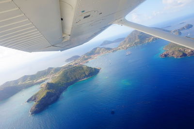 Aerial view of sea and airplane wing