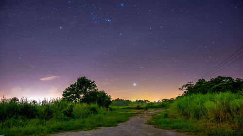 Scenic view of field against sky at night