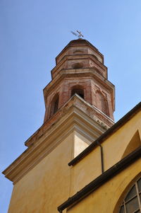 Low angle view of clock tower against clear sky