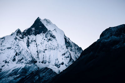 Scenic view of snowcapped mountains against clear sky