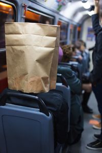 Rear view of man traveling in bus
