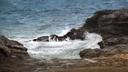 Waves splashing on rocks at shore