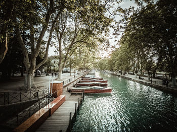 Canal amidst trees against sky