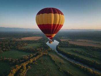 Hot air balloons flying over landscape