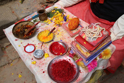 At dakshinkali temple, a man has his table set to paint holy bindus in a short ceremony.