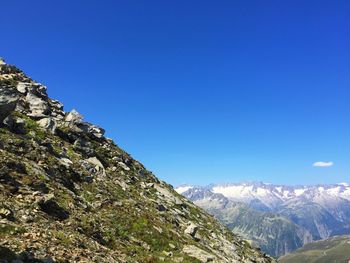 Scenic view of mountains against clear blue sky