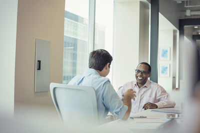 Two businessmen talking together in office