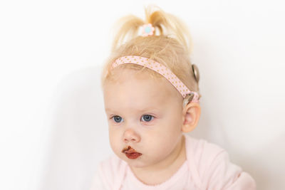 Portrait of cute baby boy against white background