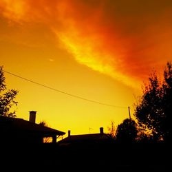 Low angle view of silhouette trees against sky at sunset