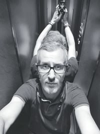 Portrait of man standing in elevator