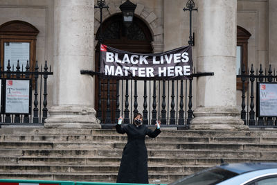 Man standing against building in city