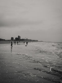 People on beach against sky