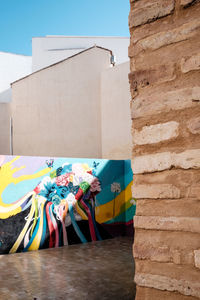 Low angle view of multi colored wall against building