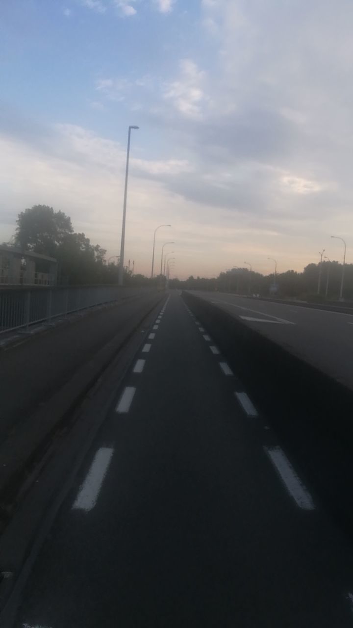 transportation, the way forward, direction, sky, diminishing perspective, road, sign, vanishing point, road marking, nature, symbol, sunset, marking, cloud - sky, no people, architecture, connection, city, street, built structure, outdoors, dividing line