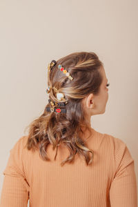 Rear view of woman with hair against white background