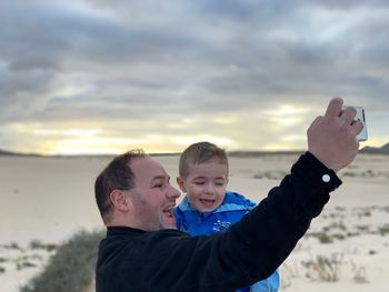 Portrait of boy on beach against sky