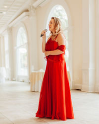 Young woman standing in corridor