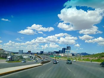 Cars on road against sky