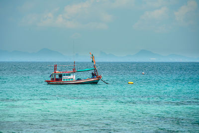 Sailboat in sea against sky