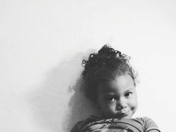 Portrait of young woman against white background