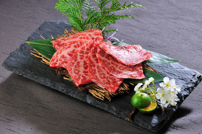 High angle view of meat on slate over table