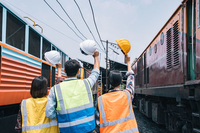 Rear view of people at train