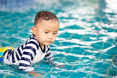 Boy swimming in pool