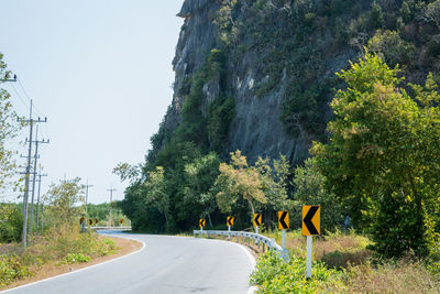 View of empty mountain road during sunny day