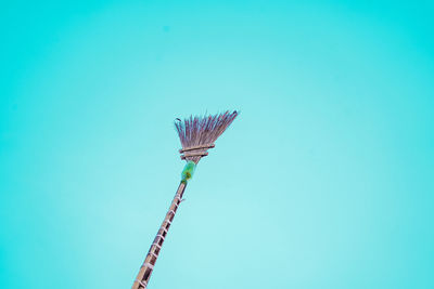 Low angle view of crane against clear blue sky