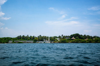 Scenic view of sea by building against sky