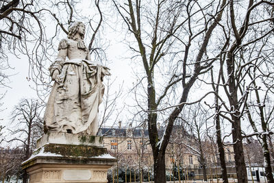 Low angle view of statue against trees