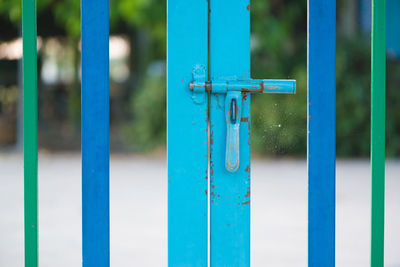 Close-up of blue metal gate