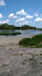 Scenic view of lake against cloudy sky